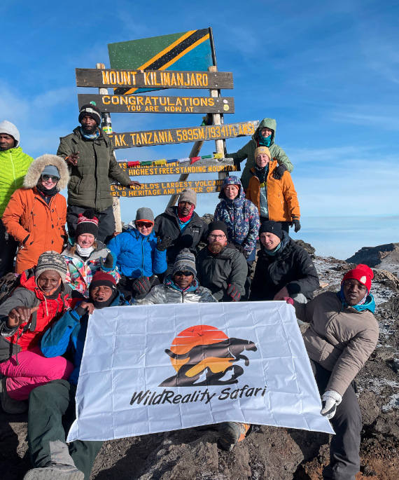 At the Summit of Mount Kilimanjaro. (Group Photo with our Travellers)